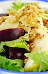 Delicious freshly made pear, beetroot and walnut salad ready to serve.