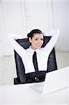 Portrait of beautiful business woman working on laptop computer