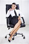 Portrait of beautiful business woman sitting on chair in office