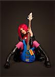 Sexy rock girl with bass guitar, studio shot