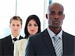 Serious brunette businesswoman in focus with her team in a line