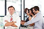 Senior leadership with crossed arms working in a call center