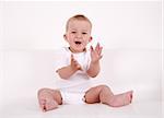 Portrait of cute baby laughing and applauding