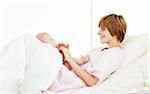 Mother playing with her baby son in hospital