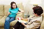 Teen girl expressing frustration in a session with her therapist.