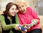 Grandmother and granddaughter playing an exciting video game together.