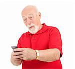 Senior man receives a surprising text message on his cellphone.  Isolated.