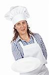 Attractive cook woman holding a empty dish isolated on white background. Dish on focus and shallow depth of field