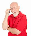 Surprised senior man talking on his cell phone.  Isolated on white.