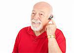 Senior man using a hands-free mobile phone ear piece.  Isolated on white.