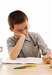 Schoolboy doing bored his homework - isolated