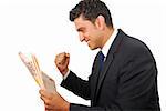 Businessman rejoicing with success while reading the newspaper