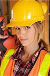 A female construction worker smiling at the camera