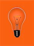 A transparent light bulb over an orange background. Tungsten glowing filament.