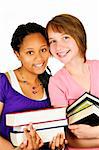 Isolated portrait of two teenage girls holding text books