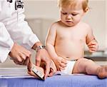 Doctor giving baby girl checkup in doctorÕs office