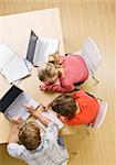 Students studying together in classroom on laptops