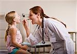 Doctor giving girl checkup in doctorÕs office