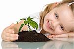 Happy smiling little girl protecting a plant - isolated