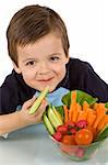 Happy little boy with a bowl of fresh sliced vegetables - isolated, closeup
