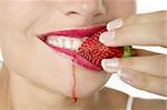 Closeup macro of woman eating a juicy strawberry