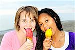 Portrait of two teenage girls eating ice cream cones