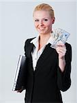 Young attractive woman holding dollars and a laptop