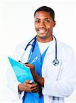 Friendly Afro-American doctor holding a clipboard and smiling at the camera