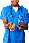 Close-up of an Young Afro-American doctor holding pills and glass of water in front of the camera