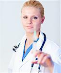 Young Serious Doctor holding a needle with hint of a smile