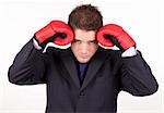 Young Businessman with boxing gloves to his head