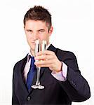 Businessman holding a champagne glass with focus on the person