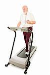 Senior man enjoys music on his mp3 player while he walks on the treadmill.  Full body isolated on white.