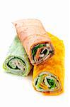 Three isolated multicolored tortilla wraps with meat and vegetables