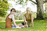 Young women sitting with dog at a park