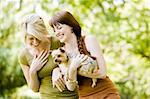 Happy Young women with dog walking in a park