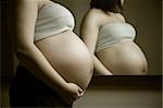 photo of pregnant woman in front of mirror