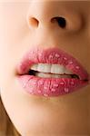 close up of pink woman mouth with little water drops on lips