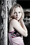 Young Pretty Woman Against Grunge Wall With Old Posters