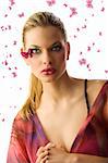 pretty blond woman  with creative makeup with butterfly on her face looking in camera surprised