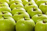 large group of granny smith apples in a row. Selective focus