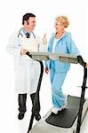 Fit senior woman on treadmill gets a thumbs up from her doctor.  Isolated on white.
