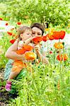 Mother showing flowers to her little daughter