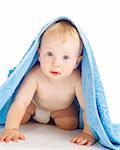 Astonished baby under the blue bath towel