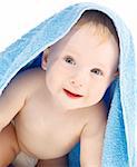 Portrait of a baby covered with a towel