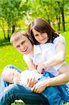 Cheerful family having fun in the summer park