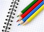 color pencils set on the spiral notepad background