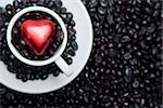Coffee cup with black beans and red heart