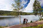 A couple on a camping trip by a lake