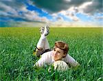 female soccer or football player lying in a grass field